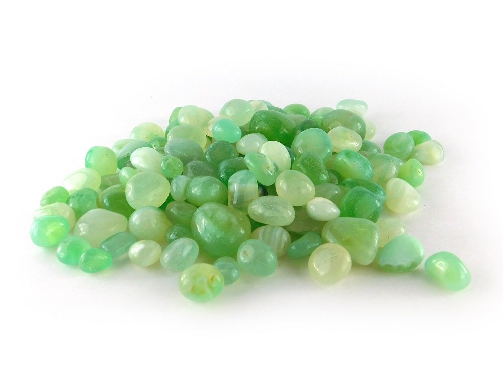 Green pebbles on a white background