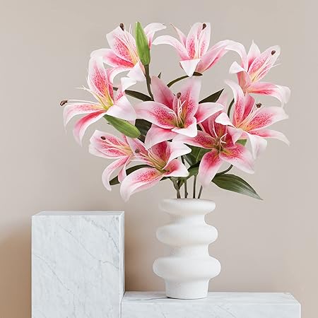 White vase with pink and white flowers on a neutral background