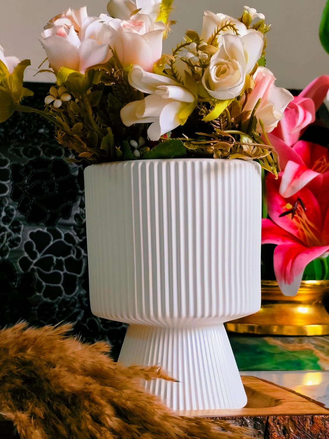 White textured vase with flowers on a decorative surface