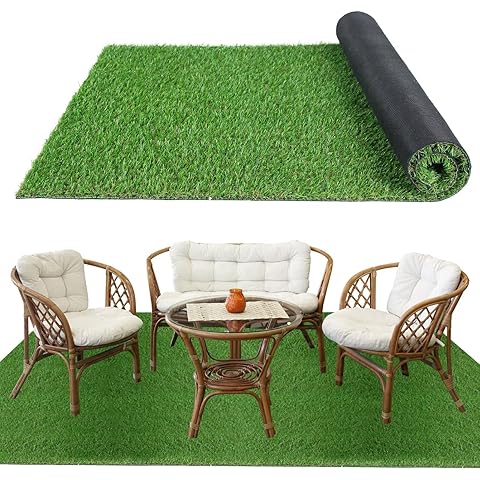 Roll of green artificial grass with a set of outdoor furniture on top