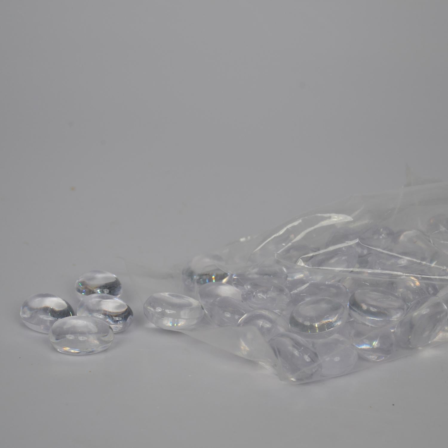 Clear plastic beads with a clear plastic bag on a gray background