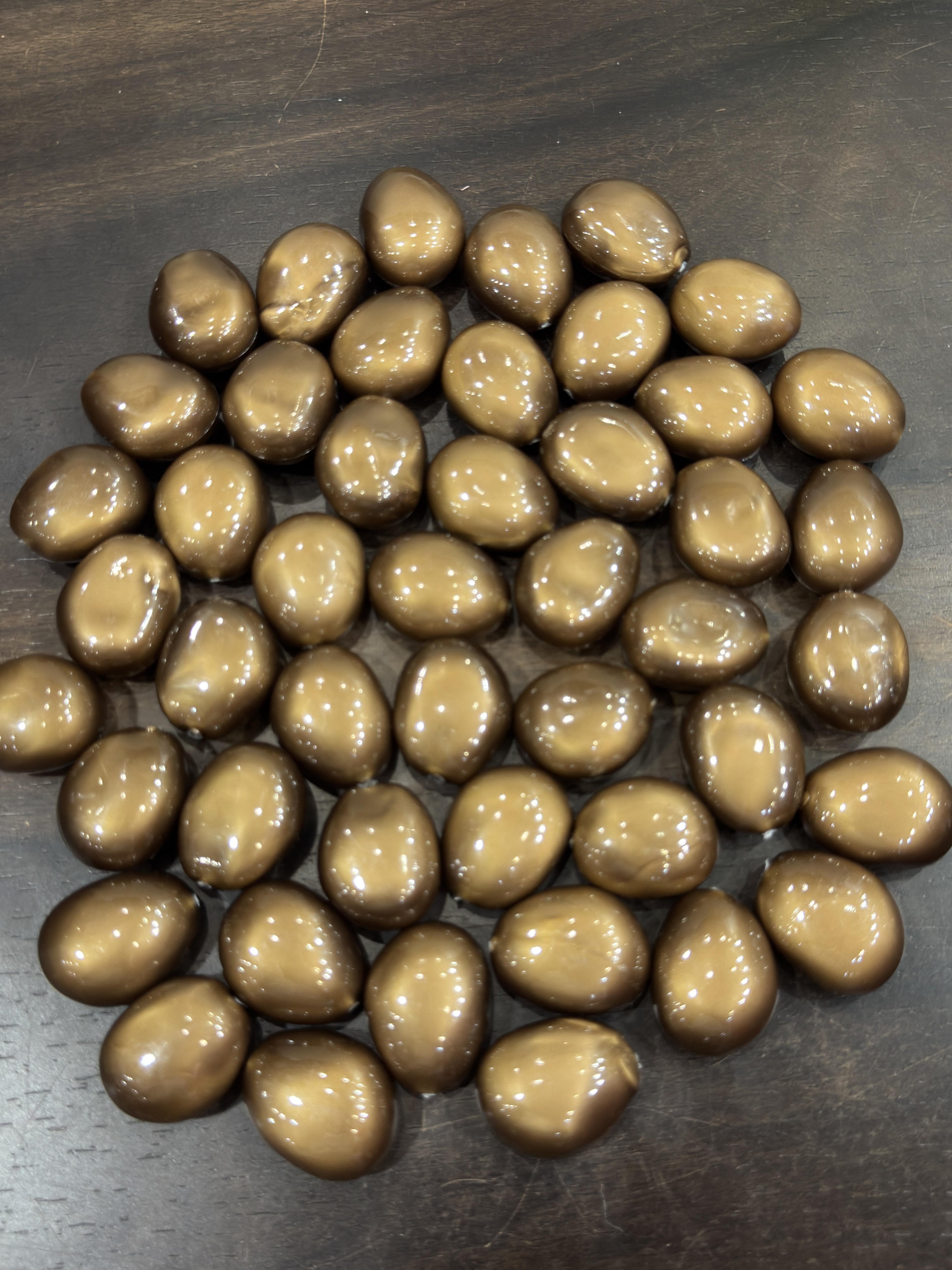 Brown pebbles on a dark surface