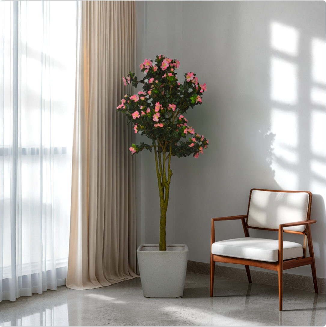 A 5 ft artificial azalea plant with vibrant green leaves, placed in a room corner next to a window, showcasing its realistic texture and color.