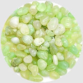 Green and white pebbles on a white background
