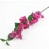 Artificial pink flower branch with green leaves on a white background