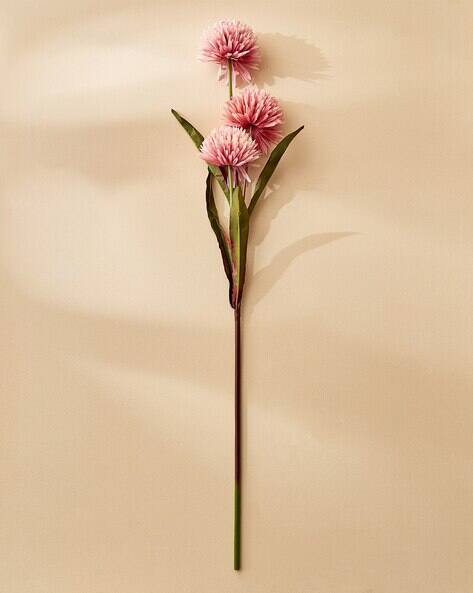 Single stem of pink flowers on a beige background