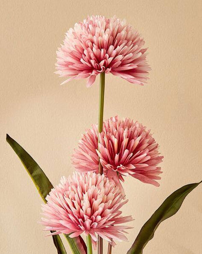 Three pink flowers with green leaves on a beige background