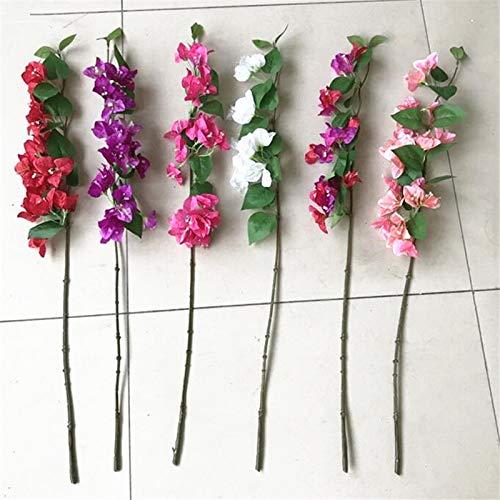 Set of artificial flower branches with pink, purple, and white flowers on a tiled floor.