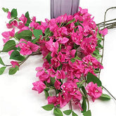 Bouquet of pink flowers with green leaves on a white background