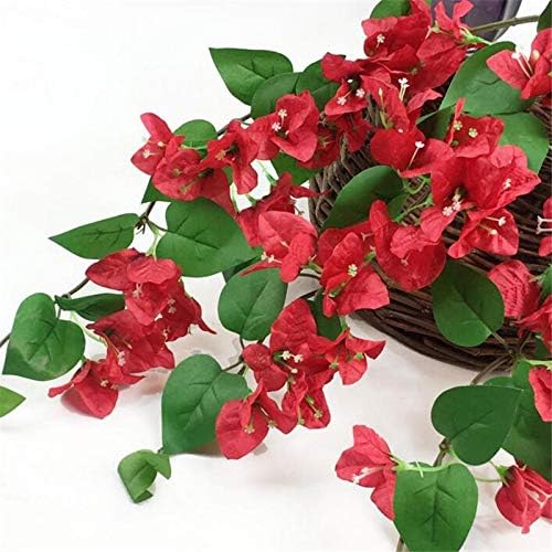 Artificial red bougainvillea flowers with green leaves on a white background