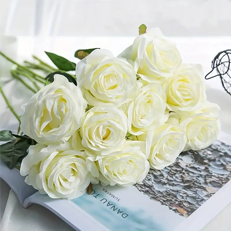 Bouquet of white roses on a magazine