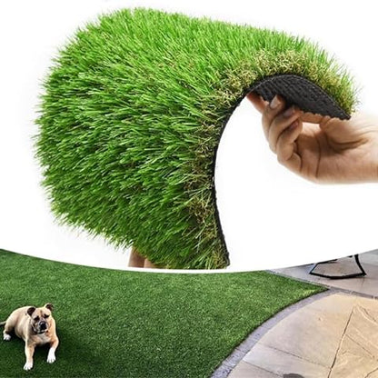 Hand holding a roll of artificial grass with a dog lying on a installed patch.