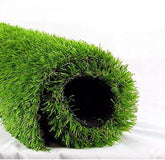 Roll of green artificial grass on a white background