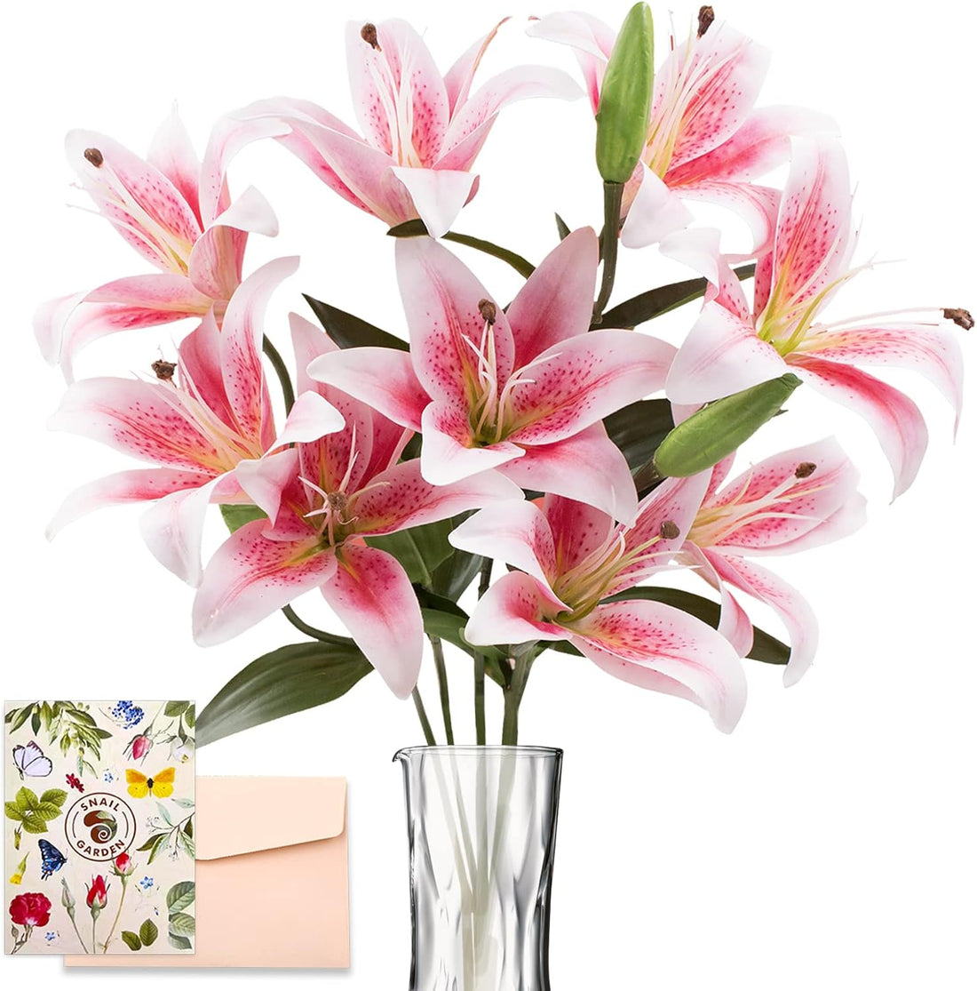 Bouquet of pink lilies in a clear vase with a decorative card and envelope on a white background