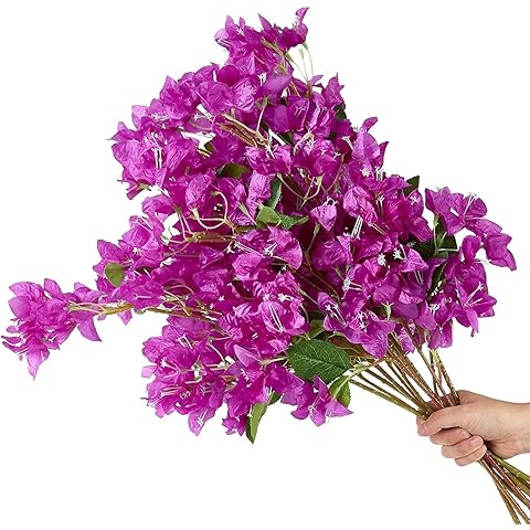 Bouquet of purple flowers held by a hand on a white background