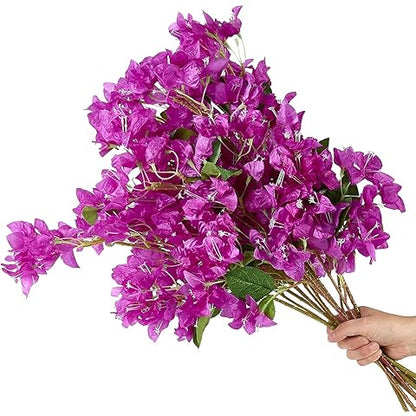 Bouquet of purple flowers held by a hand on a white background