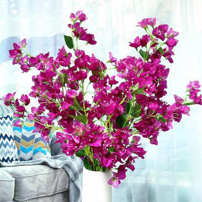 Bouquet of pink flowers in a white vase on a light blue background