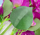 Close-up of green leaves and pink flowers with a blurred background