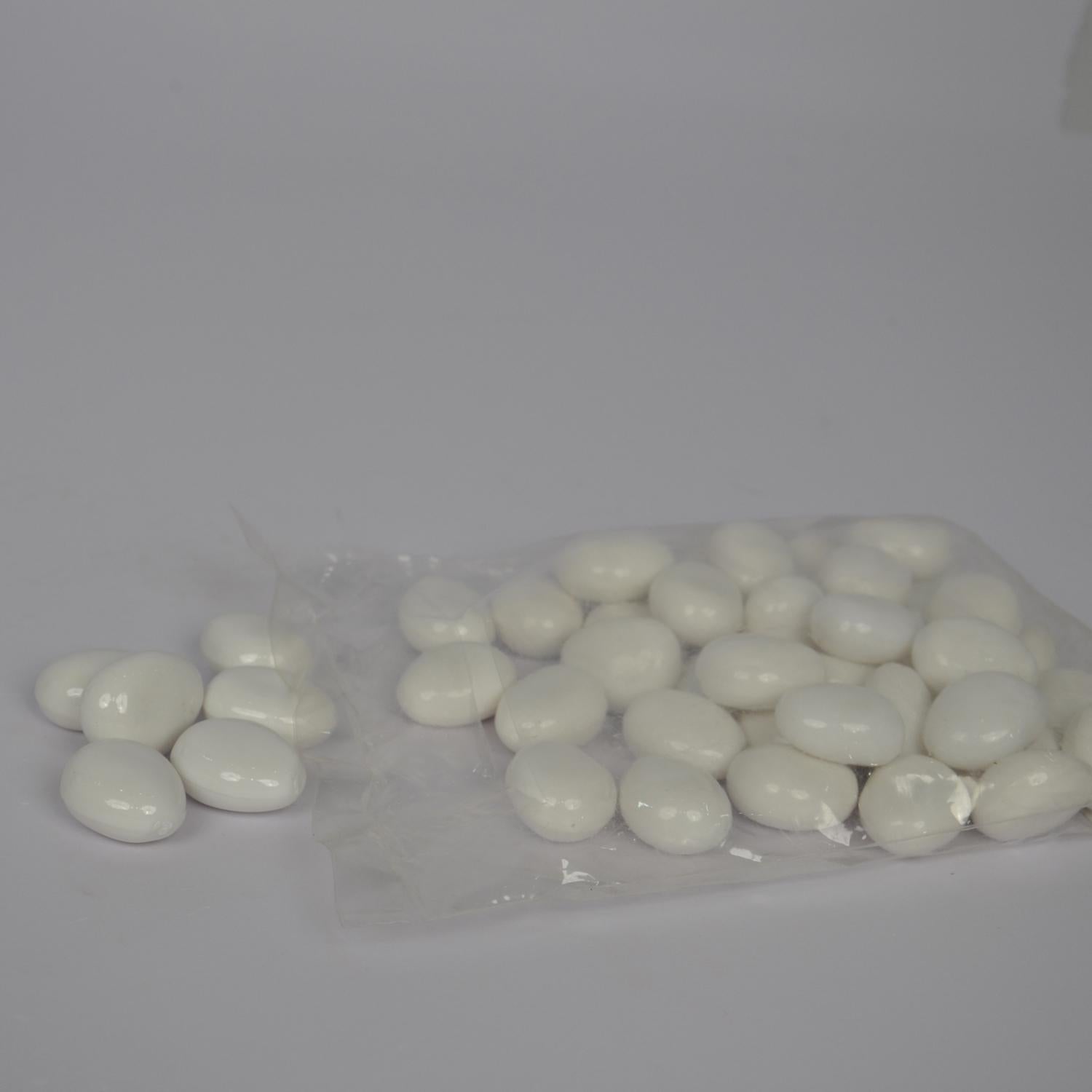 White pebbles in a clear plastic bag on a gray background