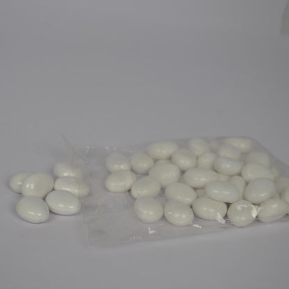 White pebbles in a clear plastic bag on a gray background