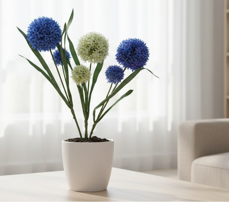 Potted plant with blue and white flowers on a table in a living room setting.