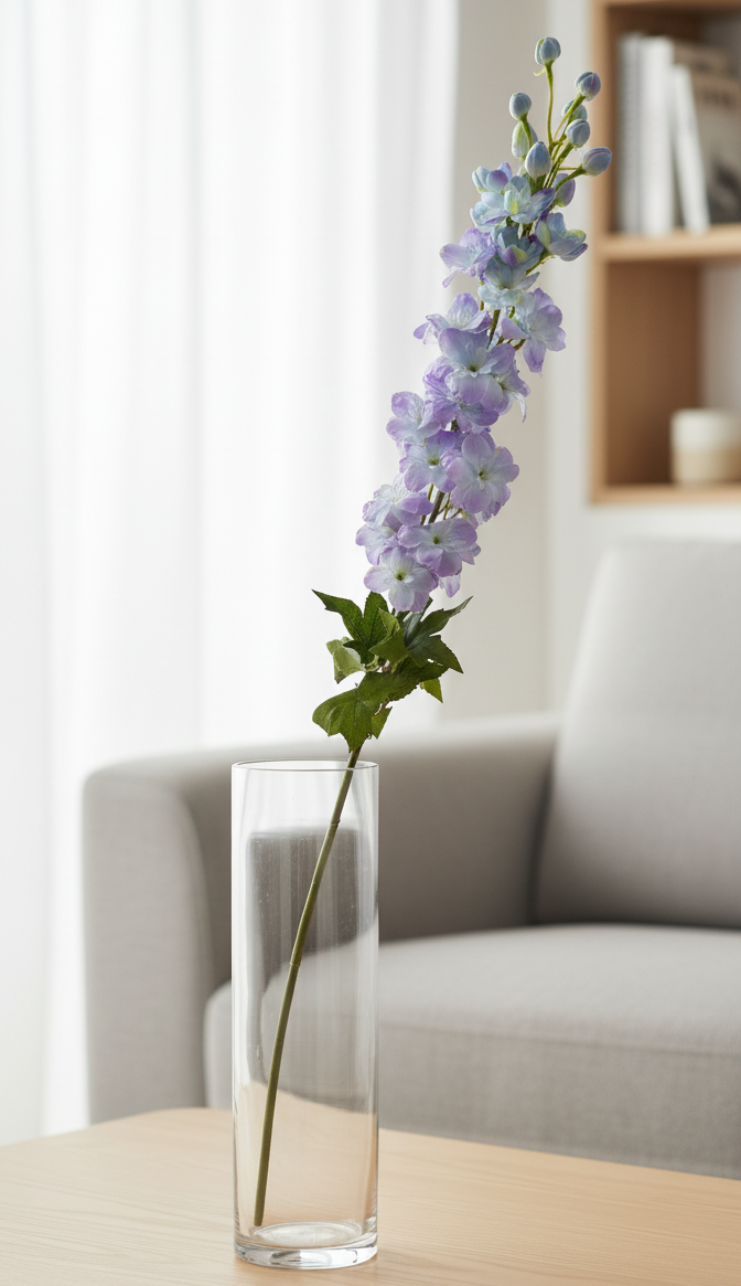 Clear vase with purple flowers on a wooden table in a living room setting