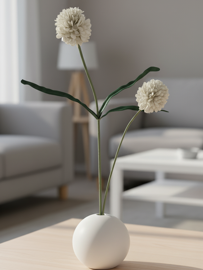 White vase with flowers on a wooden table in a living room setting