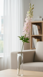 Floral arrangement in a clear vase on a coffee table with a blurred background