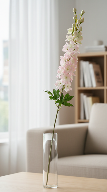 Floral arrangement in a clear vase on a coffee table with a blurred background