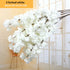 White artificial flowers with text indicating &