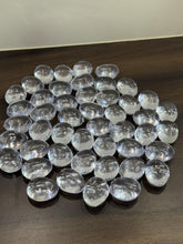 Clear glass marbles on a dark surface