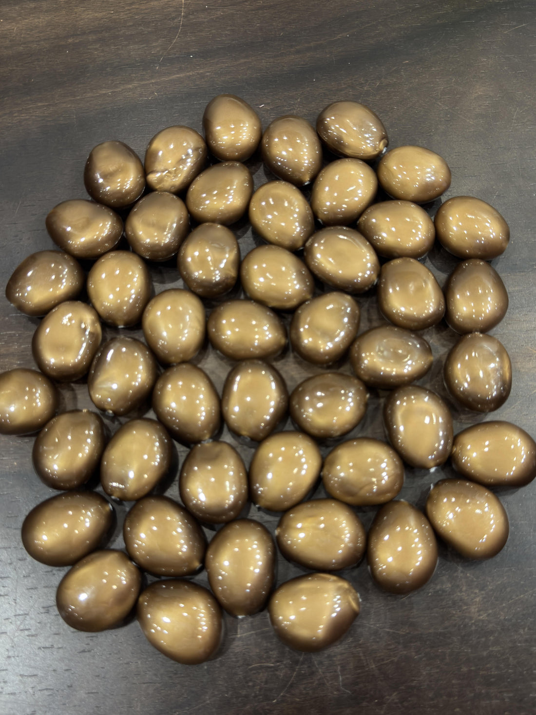 Brown pebbles on a dark surface