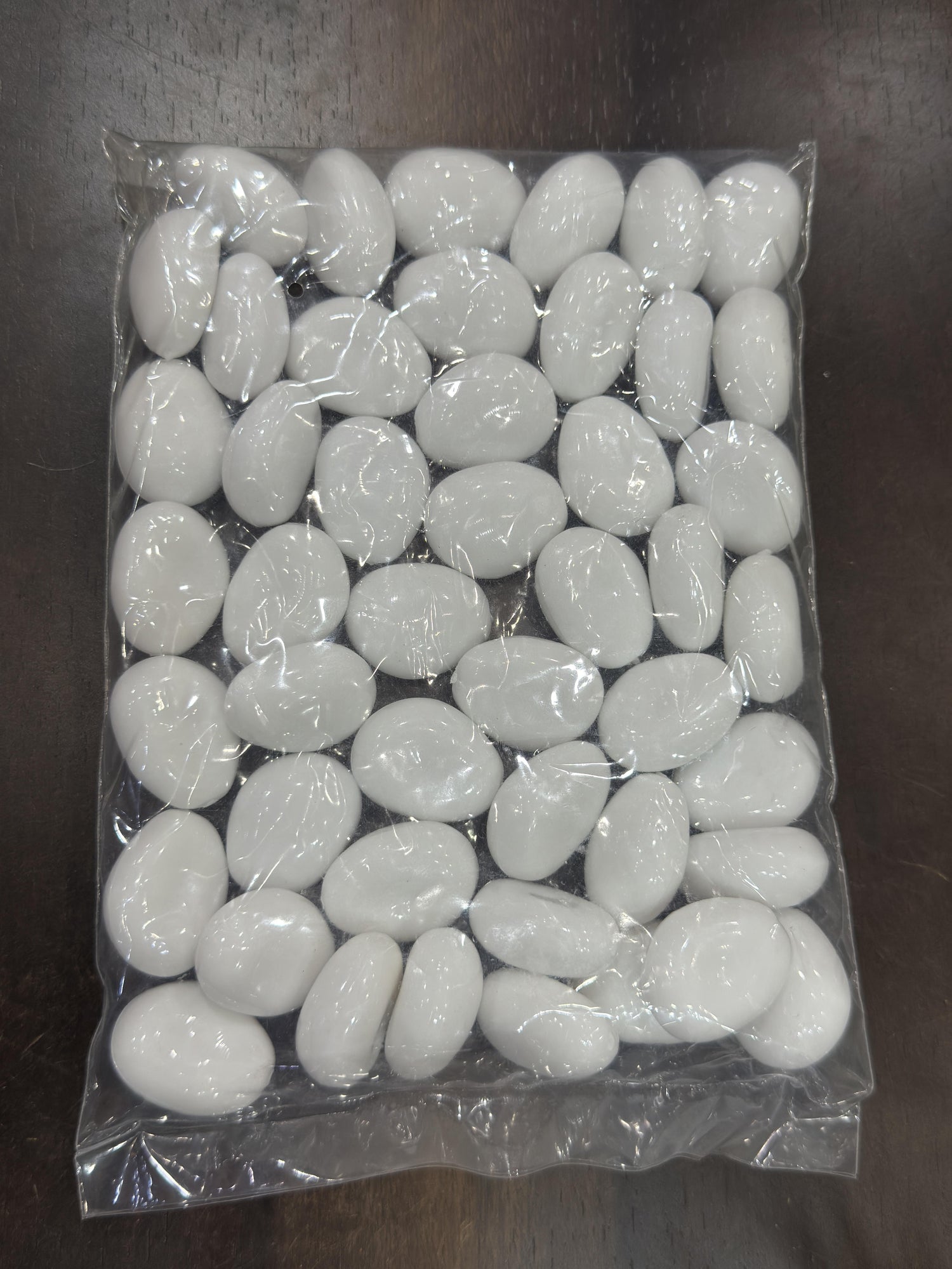 Packaged white stones on a dark surface