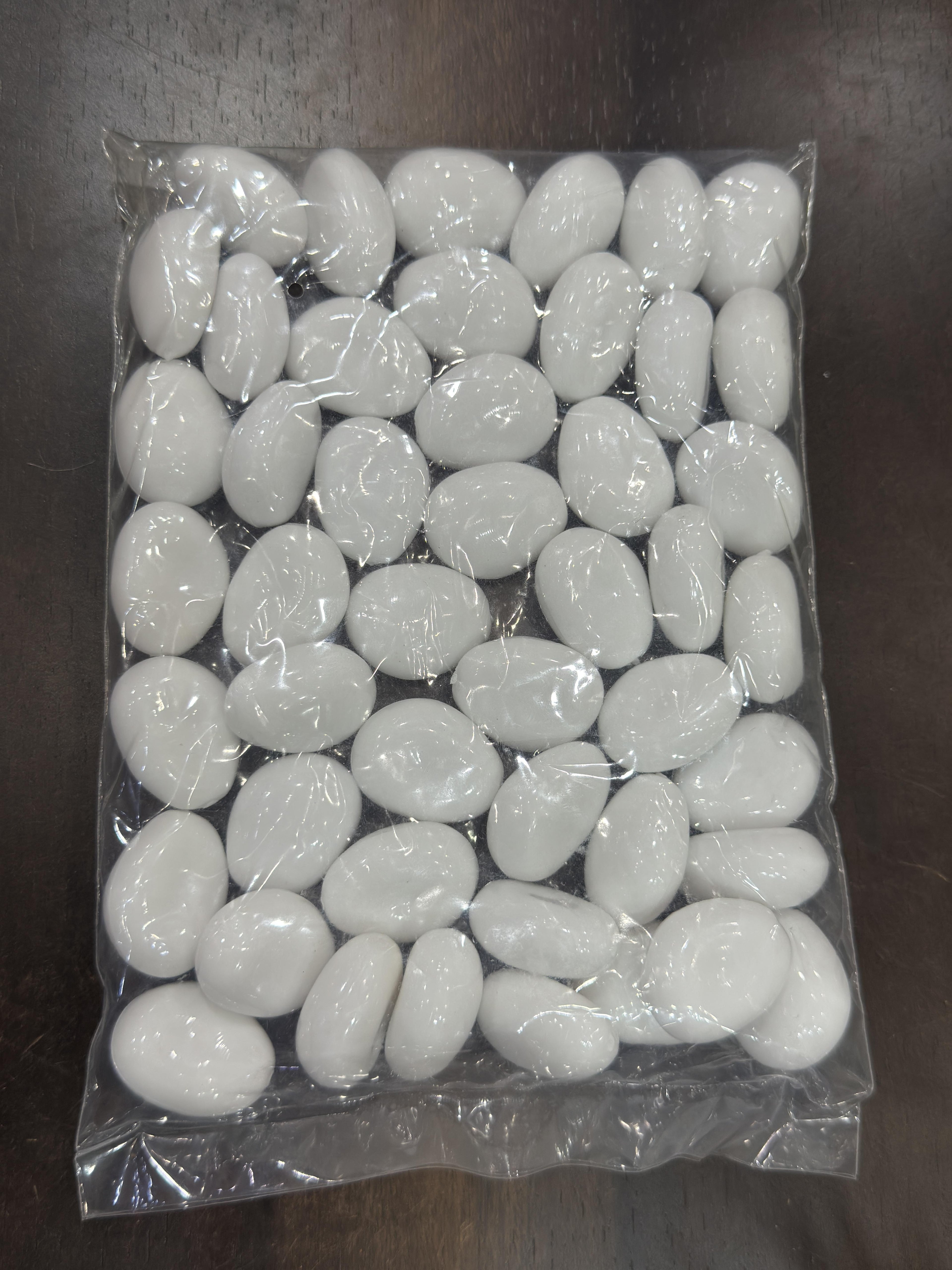 Packaged white stones on a dark surface