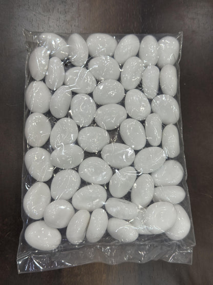 Packaged white stones on a dark surface