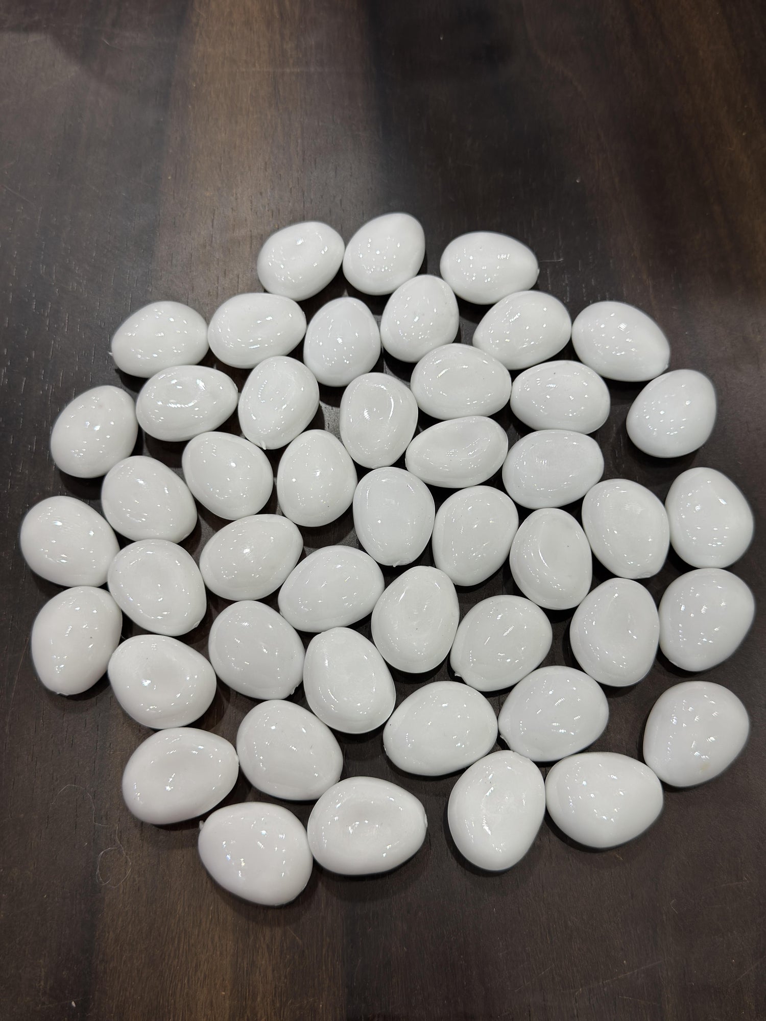 White pebbles on a dark surface