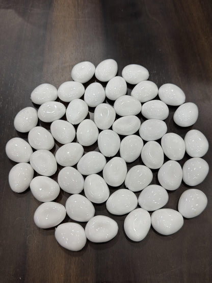 White pebbles on a dark surface
