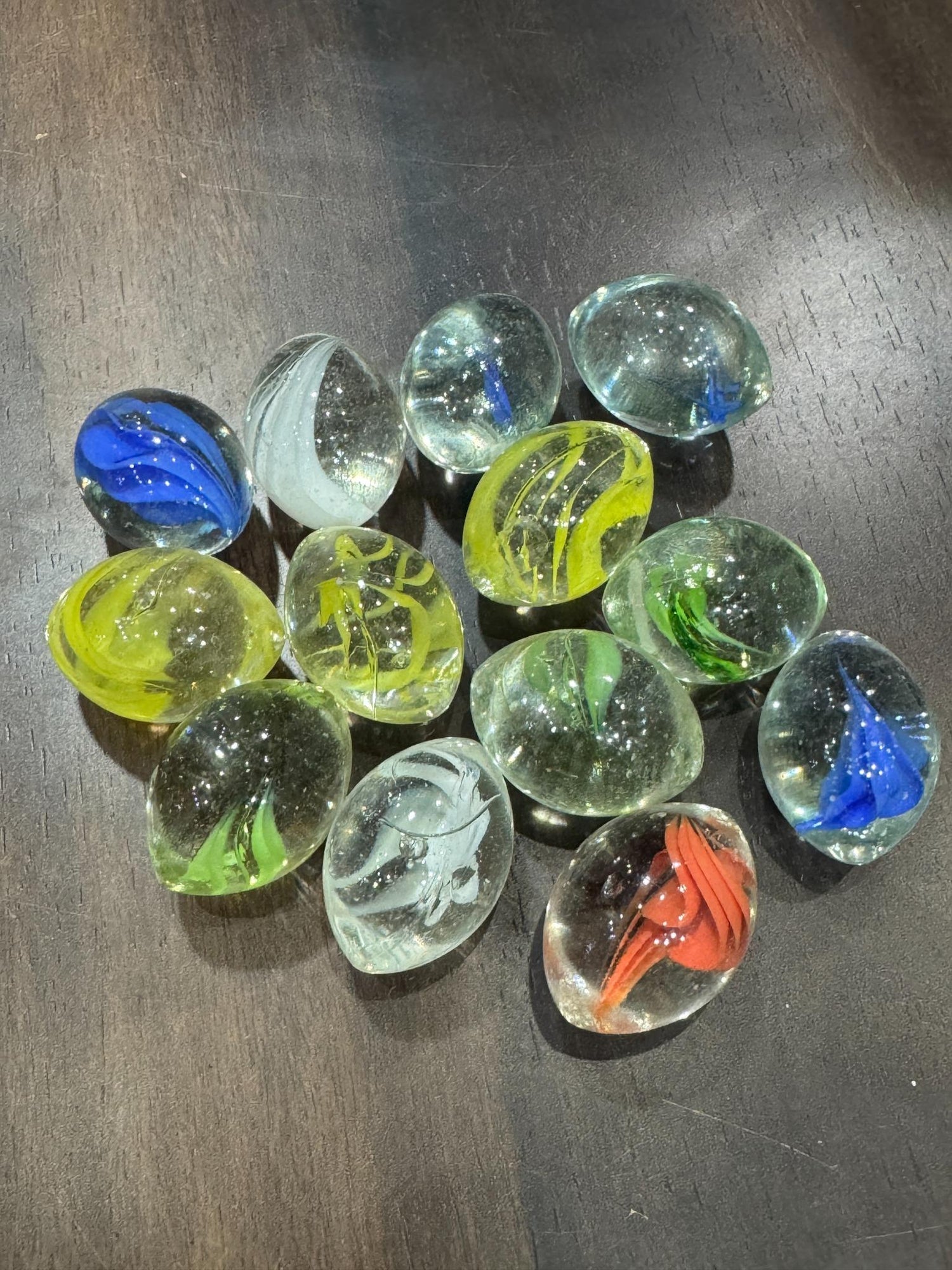 Collection of colorful glass marbles on a dark surface