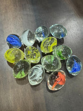 Collection of colorful glass marbles on a dark surface