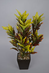 Realistic faux yellow croton plant for indoor décor
