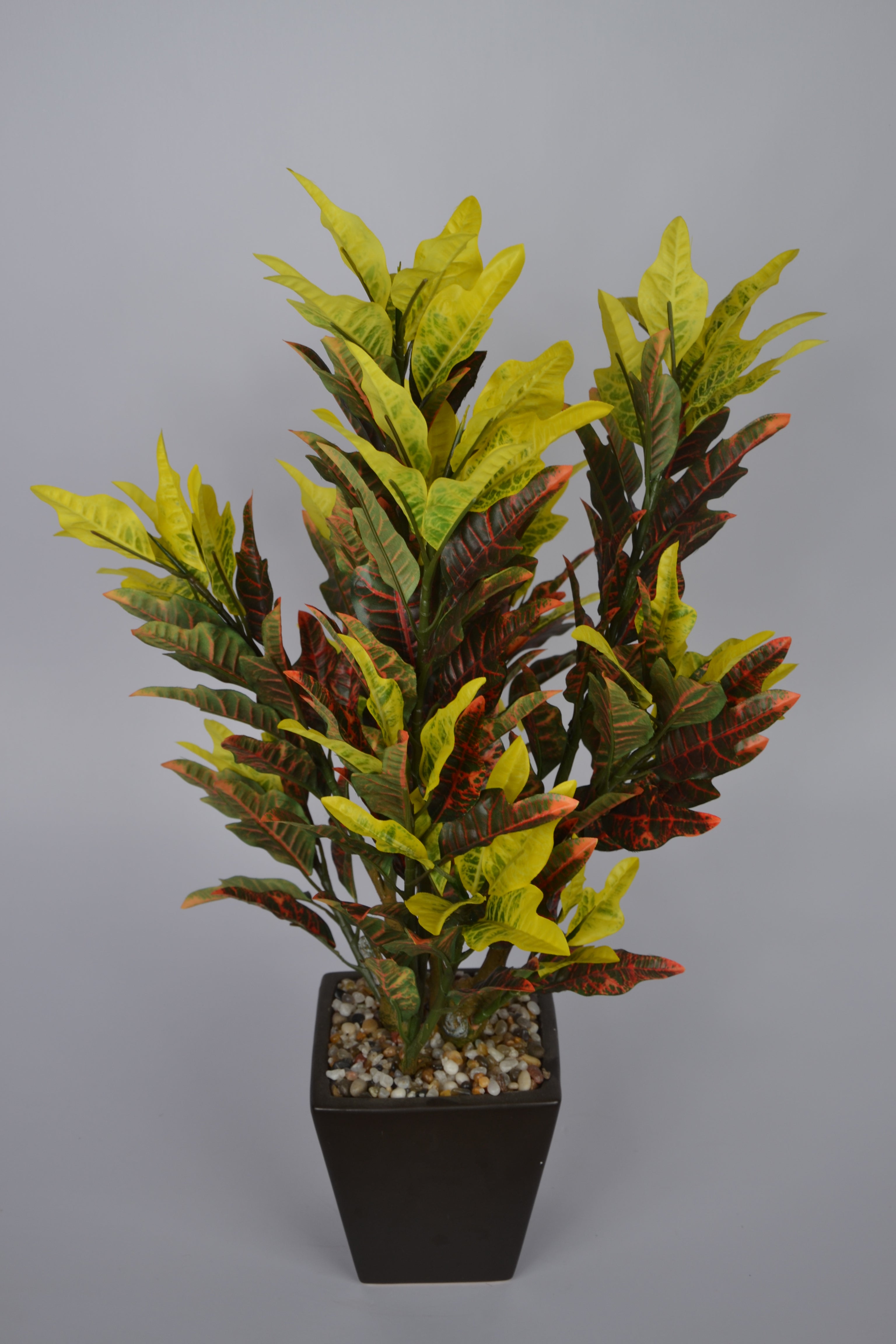 Realistic faux yellow croton plant for indoor décor
