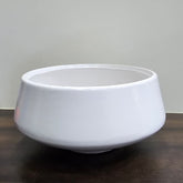 White ceramic bowl on a dark surface with a neutral background