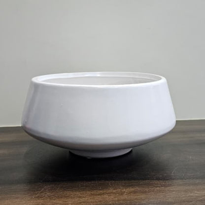 White ceramic bowl on a wooden surface with a gray background
