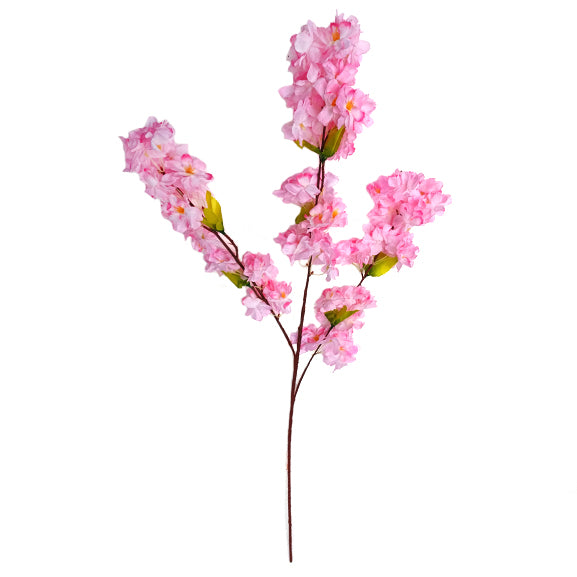 Artificial pink cherry blossom branch on a white background