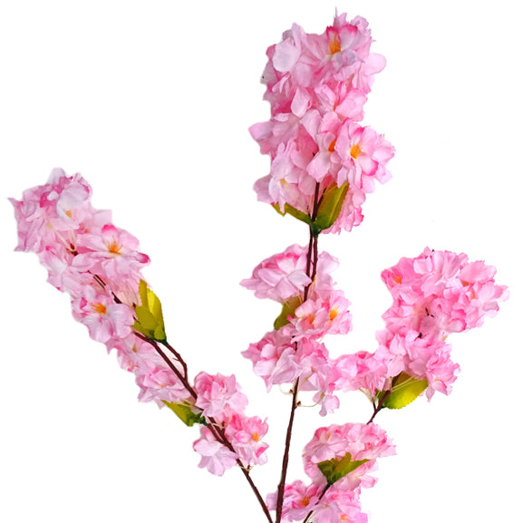 Artificial pink cherry blossom branch on a white background