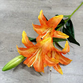 Orange lilies on a gray wooden surface