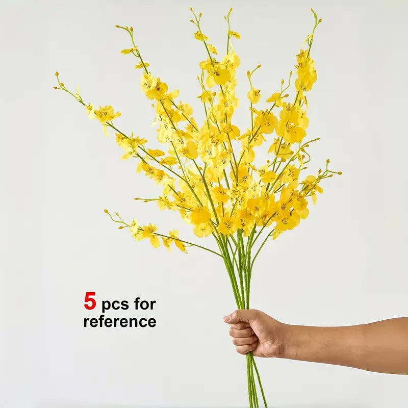 Hand holding a bouquet of yellow flowers against a light gray background