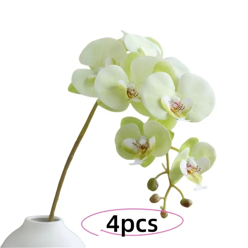 Set of four artificial orchids in a white vase on a white background