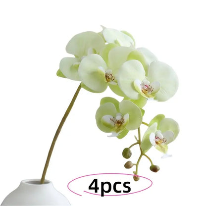 Set of four artificial orchids in a white vase on a white background