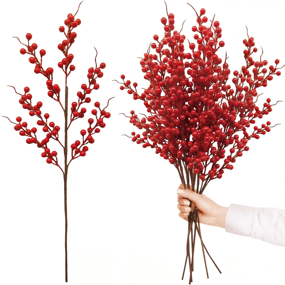 Red berry branches with a hand holding a bundle on a white background